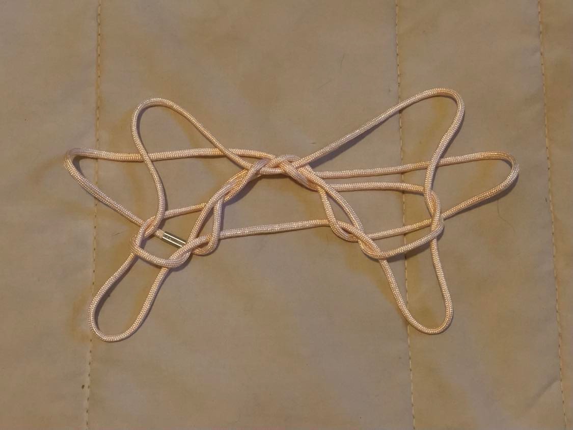 Cave Entrance string figure on a blanket