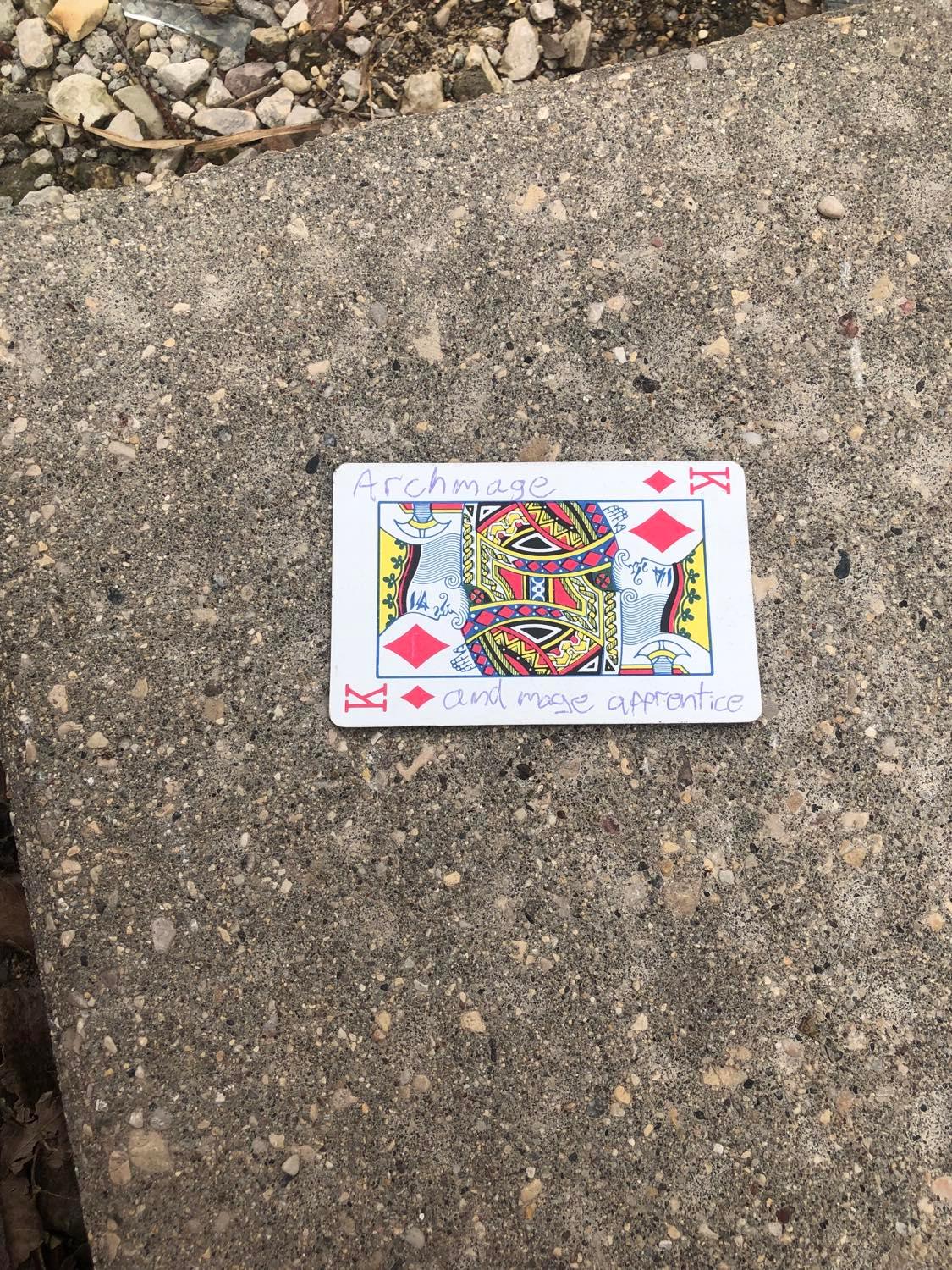 The king of diamonds, laying on the ground before the creature.