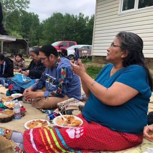 Several people at a summer feast ceremony