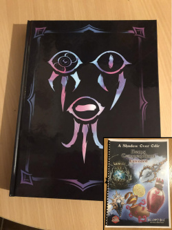 A glossy black cover with three eye like symbols on the cover, resembling a creepy looking face, and no text. Satzija's Tome of Hags.